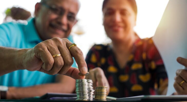 A couple determining how much they need to have in their 401(k) to retire.