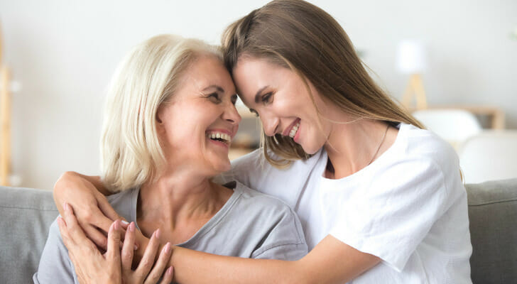 A mother and daughter embrace, having set up a living trust for the daughter's future.