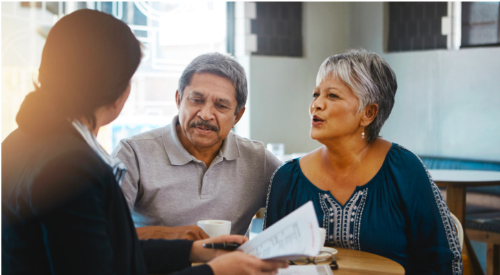 A couple discuss creating a living trust with their advisor.