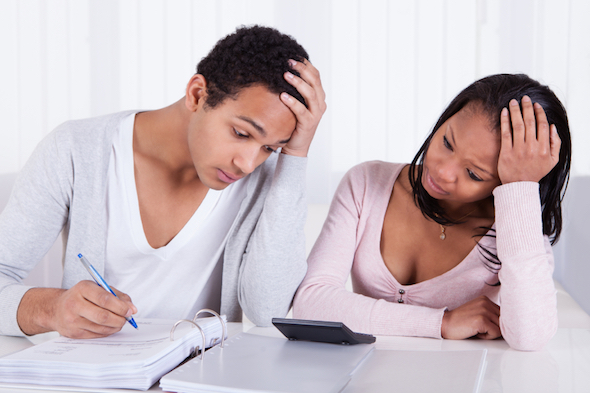 A couple filling out paperwork for a joint account.