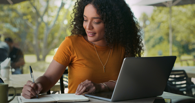 A woman taking notes on ways to reduce her tax liability.