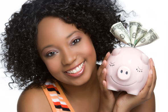 A teen holding her piggy bank.