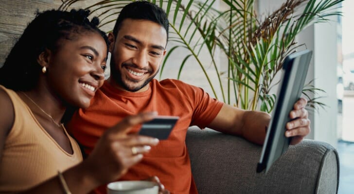 A couple reviewing their savings account balance.