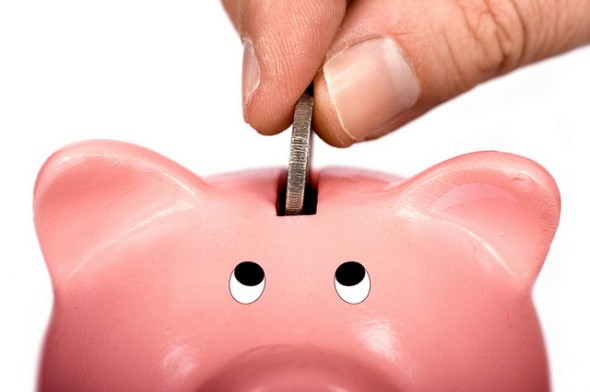 A saver puts money into a piggy bank.