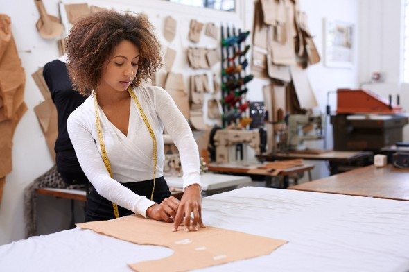 A woman working, considering the importance of an emergency fund.