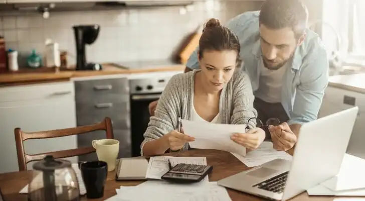 If a spouse is irresponsible with money, one solution may be to take over managing the family finances.