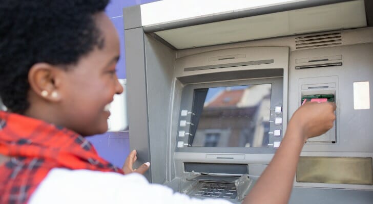 A woman using an ATM.