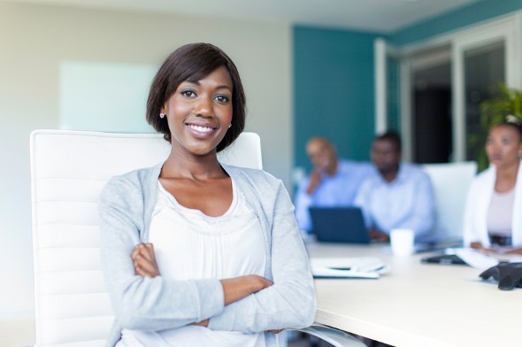 A female financial advisor sits with a group of colleagues.
