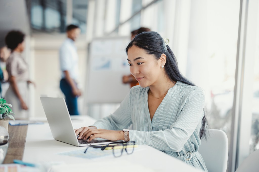 A woman looking up the income tax rate for her bracket.