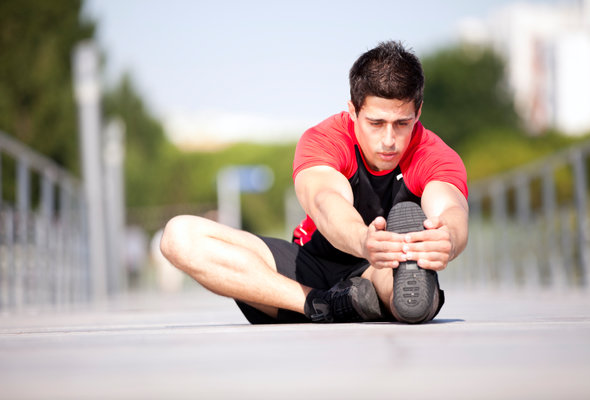 A man stretches before going for a run, content that he's avoided some of the most common refinancing mistakes.