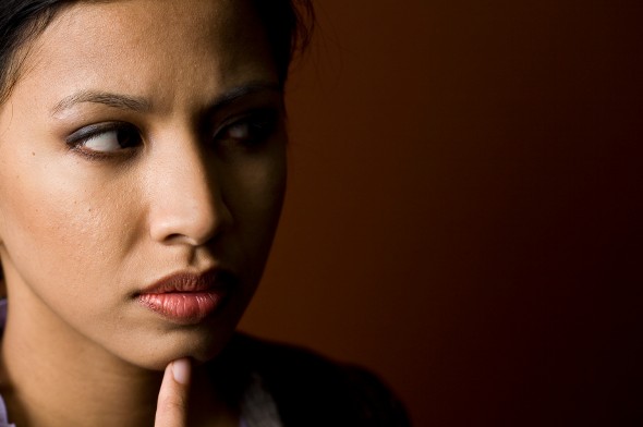 Closeup of a woman thinking about her taxes.