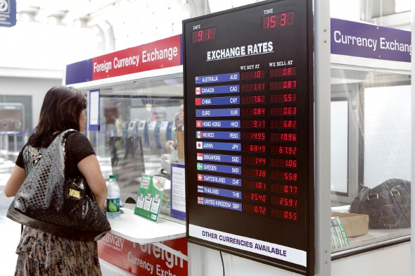 A woman reviewing exchange rates before exchanging currency.