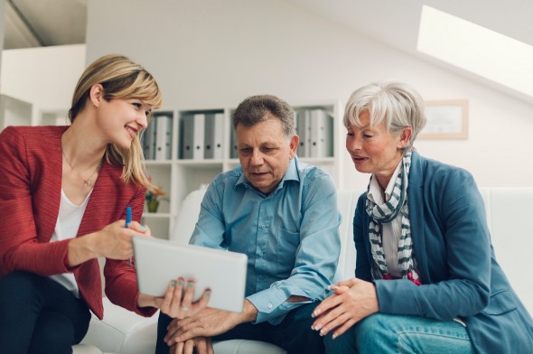 A fiduciary reviews a financial plan with clients.