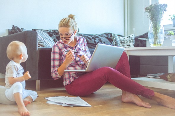 A mom working at home and speaking with her child.