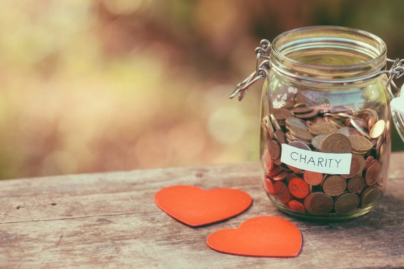 A jar of change, labeled for "charity."