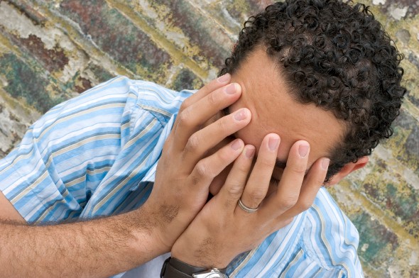 A man thinking about the drawbacks of banking with a credit union.