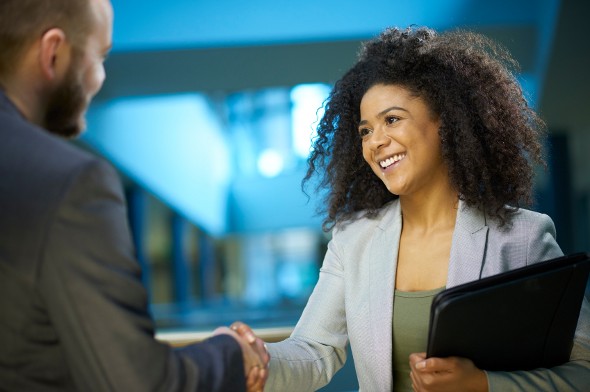 A buyer shaking hands, closing a deal on buying land.
