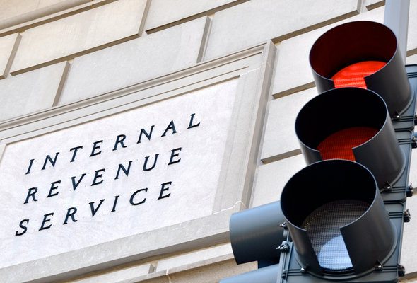 A closeup on a building with a sign that says "Internal Revenue Service."