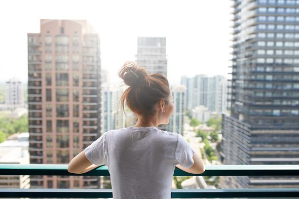 A woman enjoying the view from her condo.