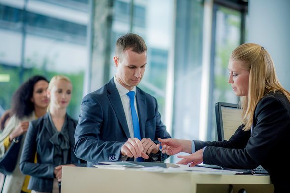 A client speaking with a bank teller at a branch.