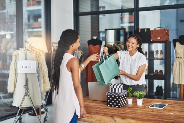 A woman making a purchase at a closing store.