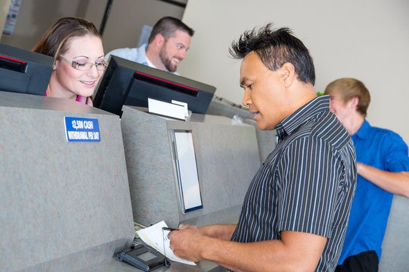 A client discussing their account with a bank teller.