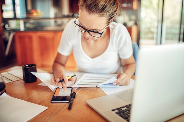 A woman reviews the differences between an ETF vs. mutual fund for her portfolio.