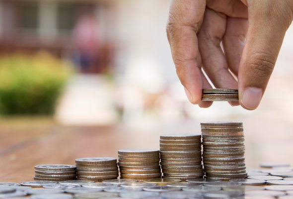 Stacks of coins organized from shortest to tallest, symbolizing financial growth.