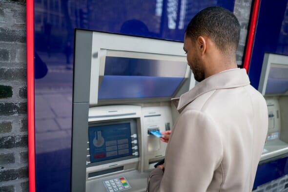 Closeup of a man at an ATM.