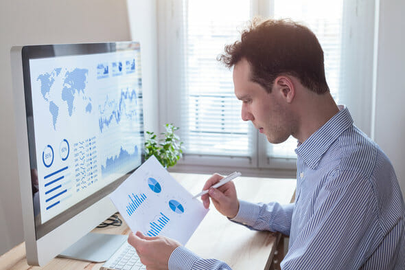 A man sits down to make an investment plan.