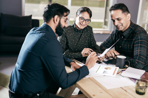 An advisor meeting with clients to discuss a portfolio.