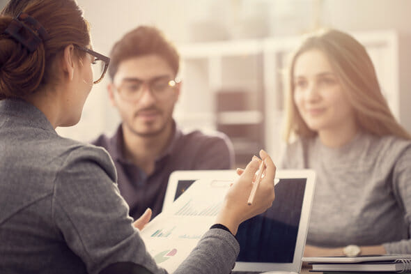A couple meets with their advisor to discuss financial advisor disclosures.