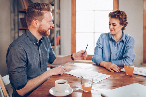 A woman sits down with her financial coach.