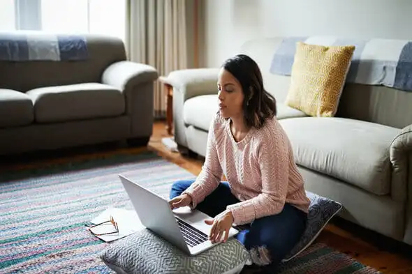 A woman sits down to create an investment plan.