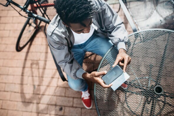 A man reviews the differences between Ally Bank vs. Capital One.