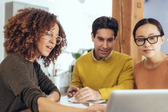 A couple sit with their advisor, comparing Ally Bank vs. Capital One.