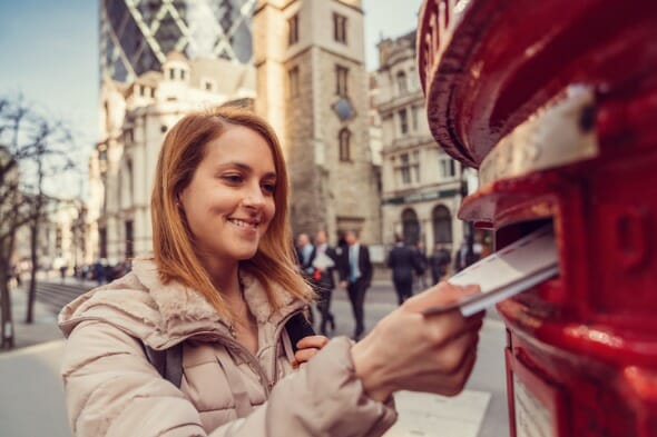 A woman mailing out a money order.