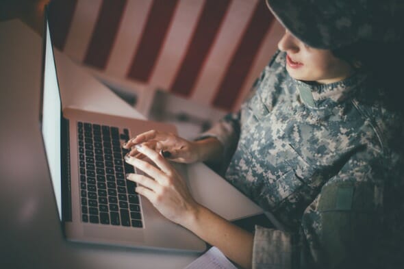 A soldier checking her bank accounts online.