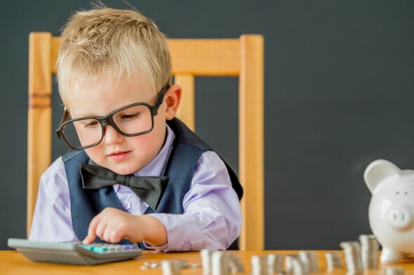 A child counting the money in his piggy bank.