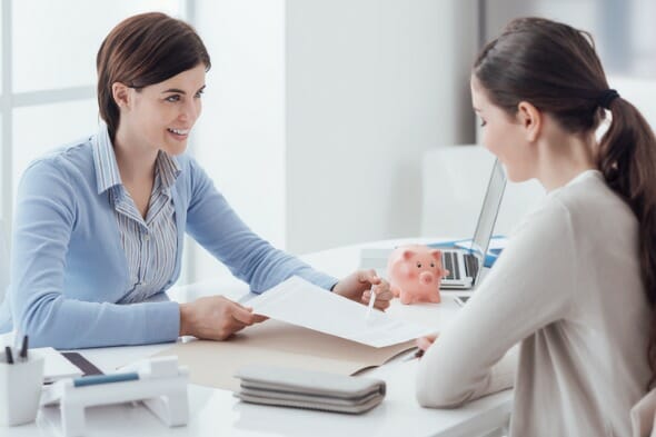 A woman opening a checking account at a bank.