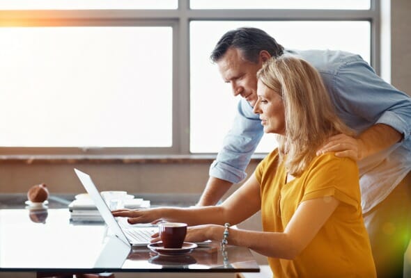 A couple evaluating how much they will need to save for retirement.