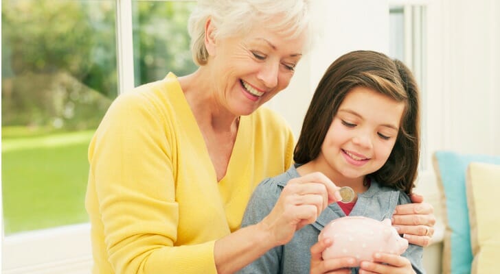 A grandmother and granddaughter saving money for the future.