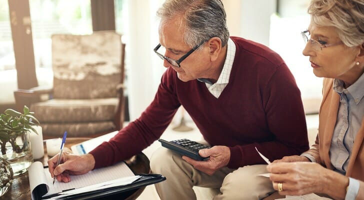 A couple researching the difference between a pension vs. an annuity.