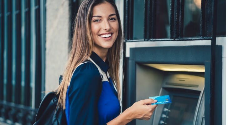 A woman using an ATM machine.