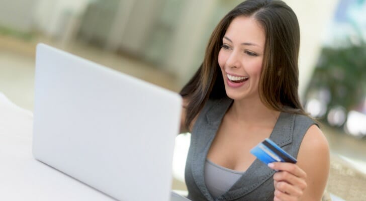A woman comparing U.S. Bank vs. Wells Fargo bank accounts.