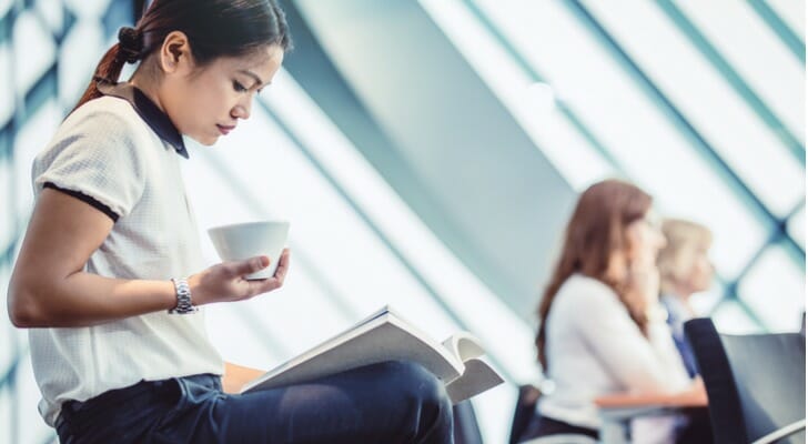 A woman reading more about different banks.