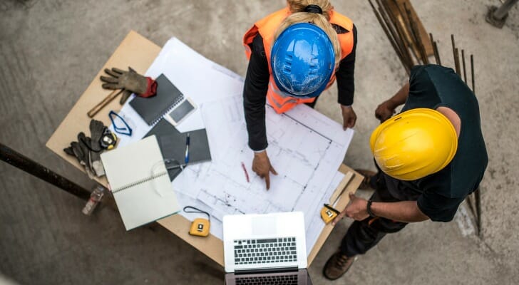 Construction workers looking at a blueprint.