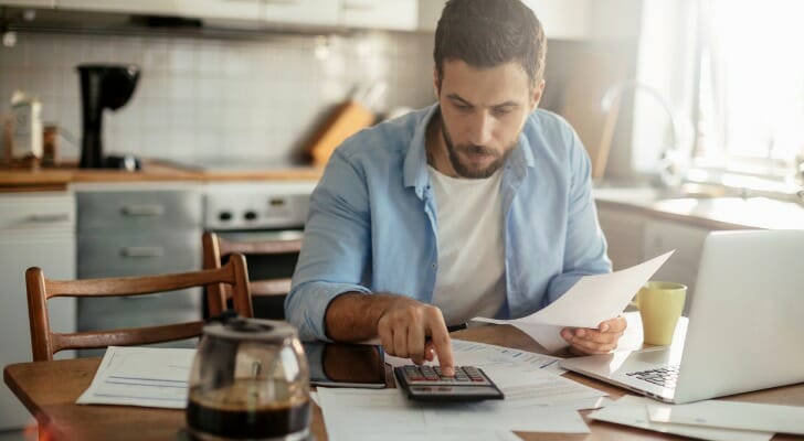 A man balancing his bank statement.