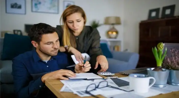 A couple comparing different bank accounts.