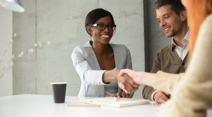 Clients meeting with a bank manager at a branch.